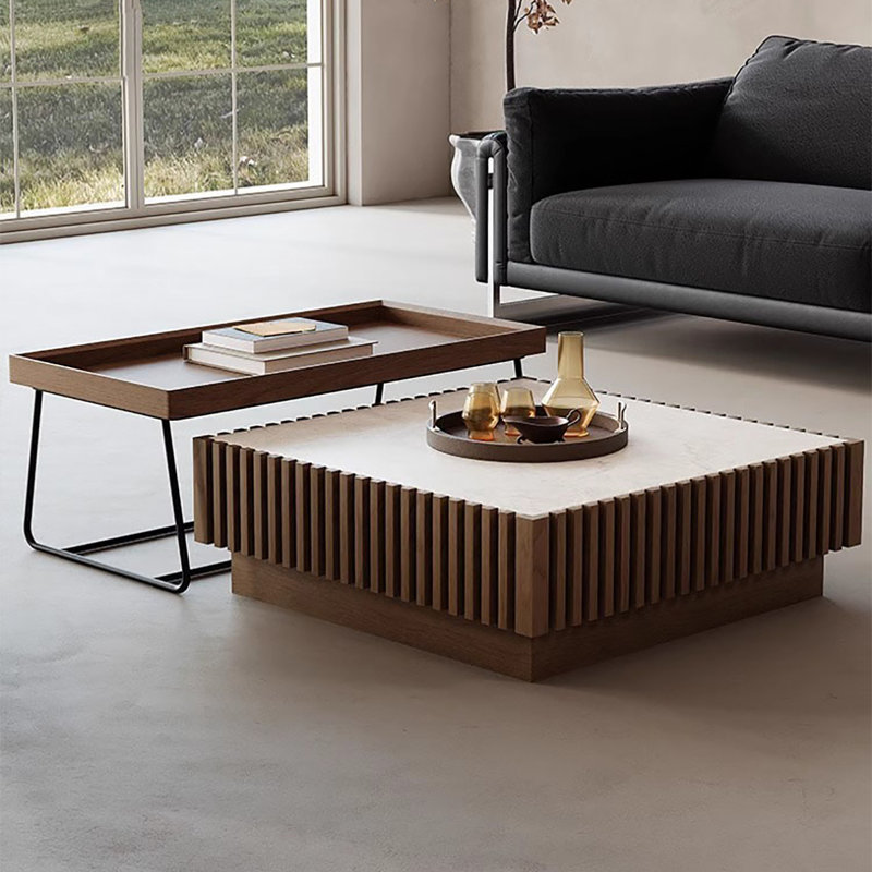 A mid-style walnut-colored coffee table set