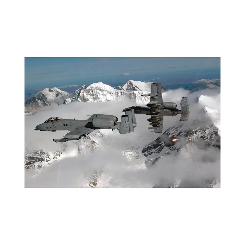 A-10 Thunderbolt IIs Fly Over Mountainous Landscape by Stocktrek Images - Wrapped Canvas Print