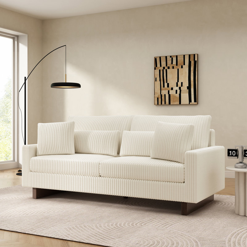 Canapé moderne en velours côtelé avec quatre coussins, mousse haute densité et support à ressorts pour un salon confortable.