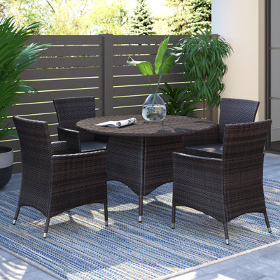 Antuna 4 - Person Wicker Patio Dining Set with Round Table