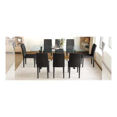 Ensemble de salle à manger moderne avec plateau en verre trempé, pieds en métal noir en forme de X et chaises en cuir synthétique - Design élégant et durable