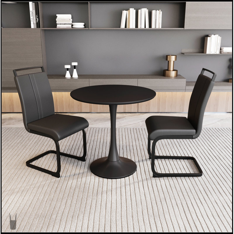Élégante table de salle à manger circulaire noire avec plateau en panneau de fibres à densité moyenne, base tulipe et 2 chaises en cuir synthétique pour espaces compacts