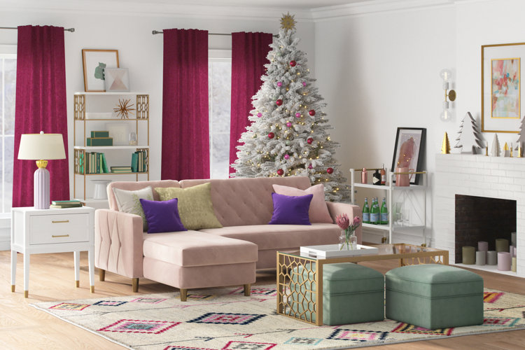 White christmas tree decorating ideas with a large white christmas tree and small pink and red bulb ornaments and yellow lights and gold star tree topper