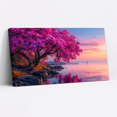 Arbre aux fleurs roses sur un rivage rocheux au coucher du soleil, tableau sur toile