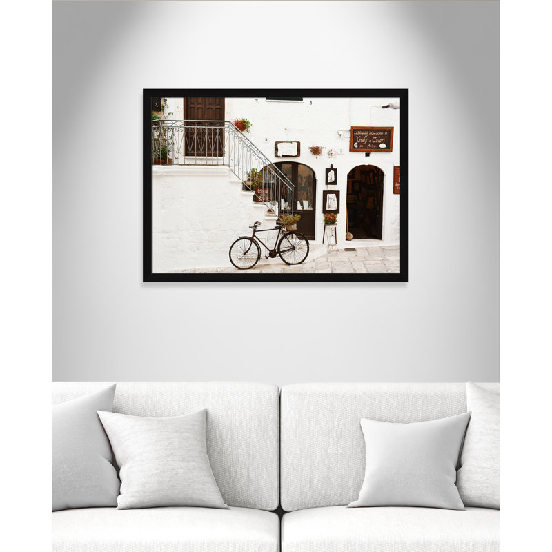 La Bottega D'Arte by Bogdan Dada, 26.5" H x 36.5" W x 0.75" D, Black Framed
