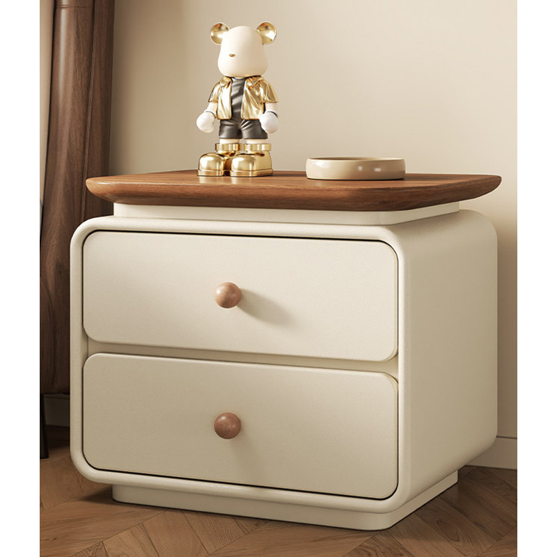 Table de chevet minimaliste de couleur crème, avec des tiroirs en bois massif et des rails coulissants silencieux, convient à une utilisation dans la chambre à coucher.