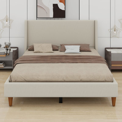 Lit plateforme tapissier moderne avec tête de lit à oreilles et pieds en bois