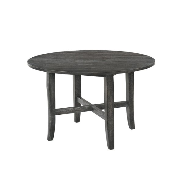 a gray round rustic dining table