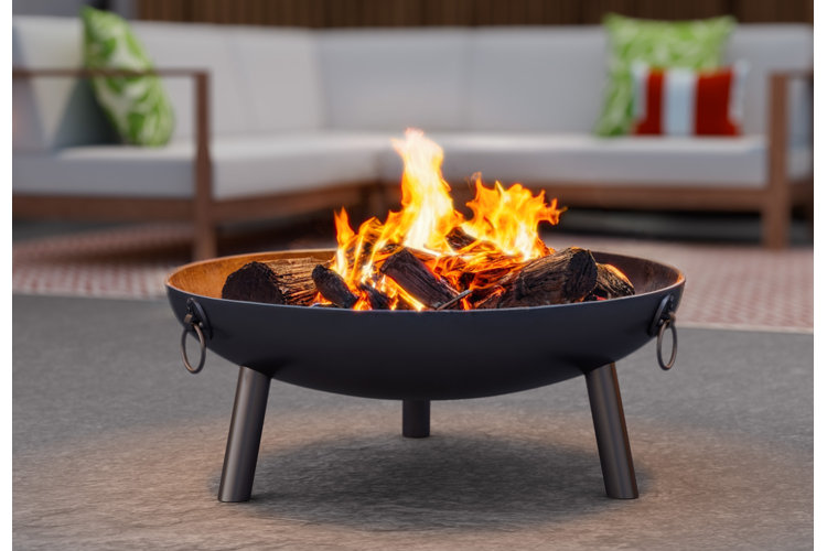 cast-iron fire pit with burning logs