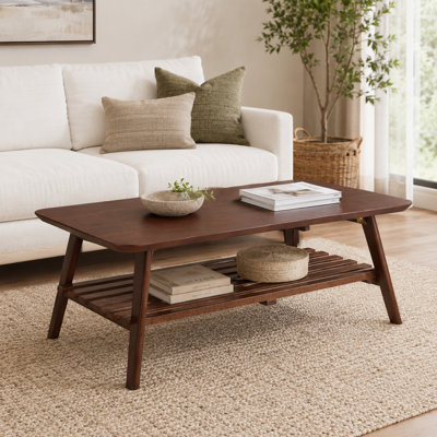 A rectangular wooden coffee table for the living room, featuring a medieval retro design, a brown walnut top, and added storage shelves, combining dec