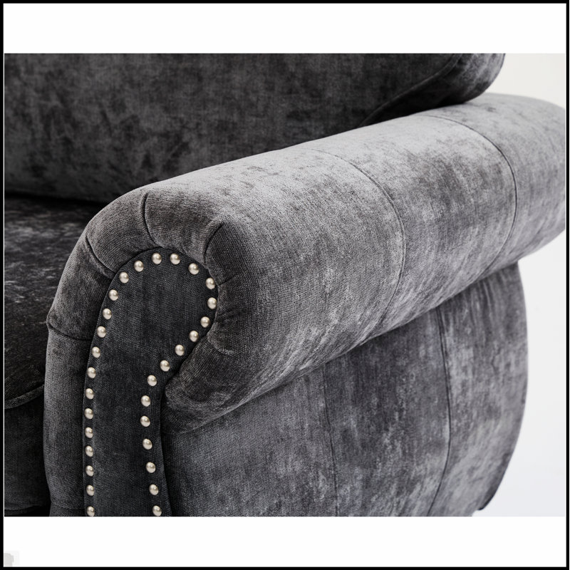 Luxueux canapé modulaire en chenille avec accoudoirs roulés et rivets, parfait pour les réunions confortables et élégantes.