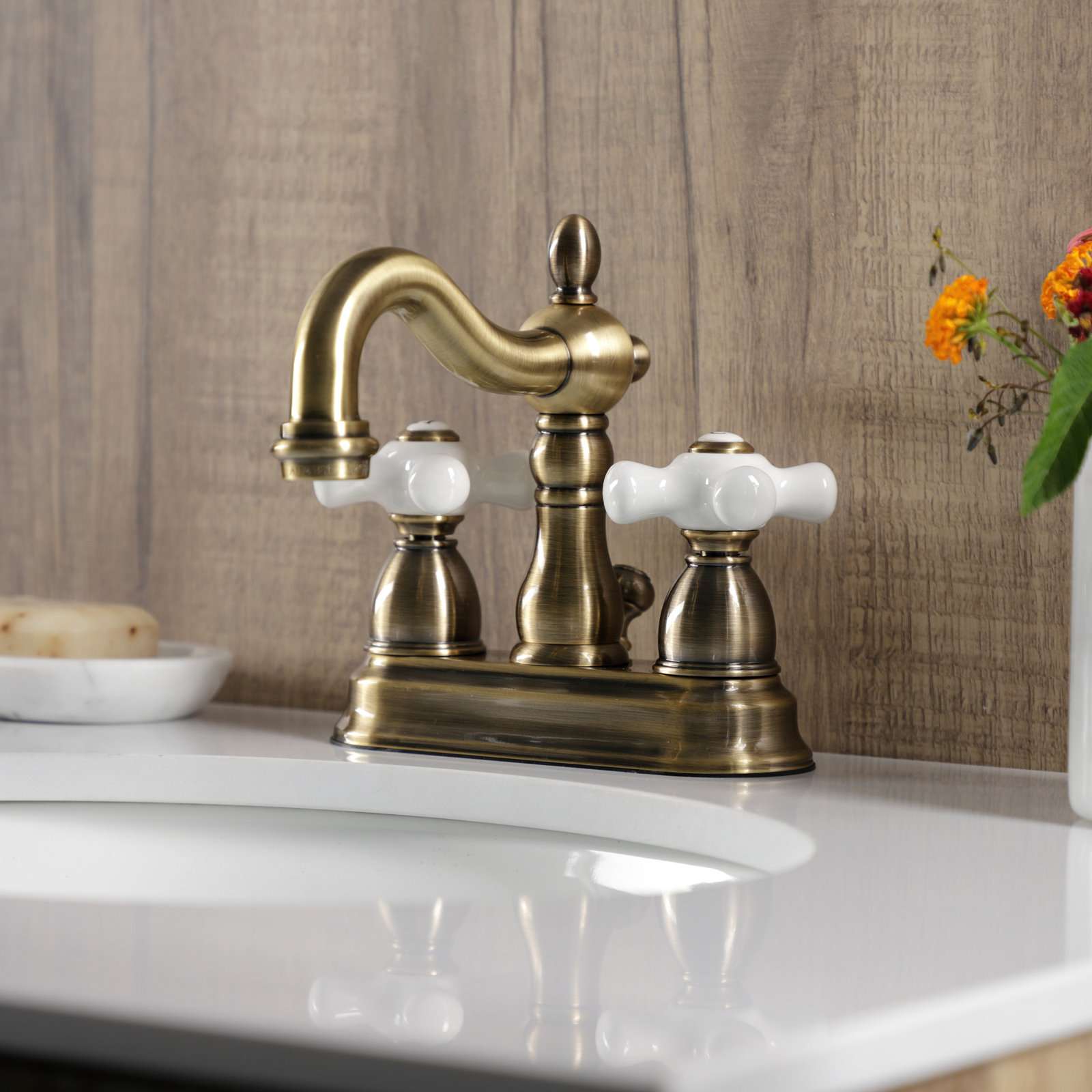 Kingston Brass Heritage Two-Handle 3-Hole Deck Mount 4" Centerset Bathroom Faucet with Plastic Pop-Up, Vintage Brass
