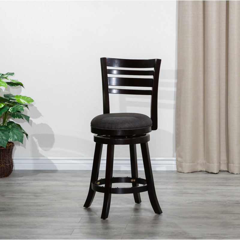 Tabouret de bar confortable, siège en tissu gris anthracite, matériaux de qualité utilisés, pieds évasés et repose-pieds en métal pour un confort accru