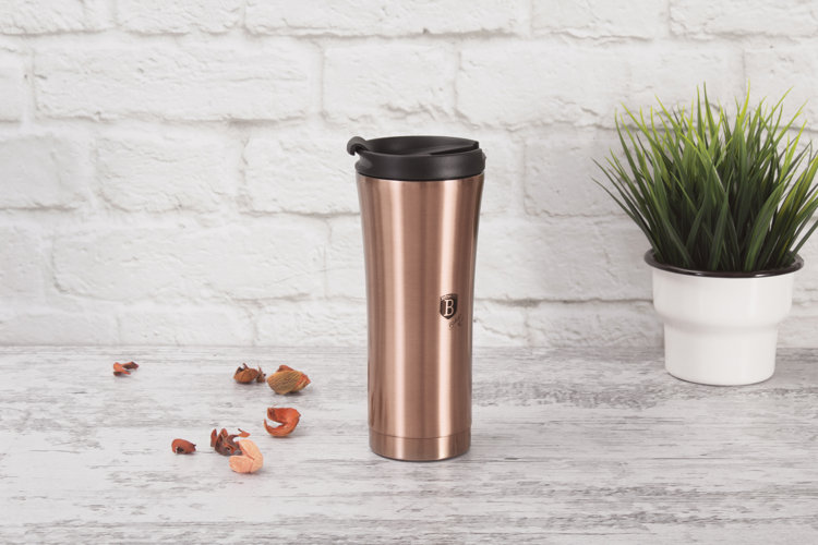 rose-gold stainless steel tumbler with a black lid on a white kitchen countertop