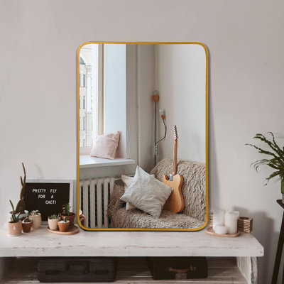 Le miroir de salle de bain rectangulaire en métal doré pour mur ajoute élégance et beauté réfléchissante à tout espace.