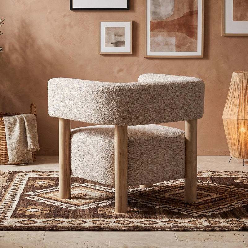 Fauteuil d'appoint moderne en tissu bouclé, avec structure en bois d'hévéa et pieds cylindriques épais, idéal pour le salon ou le bureau.