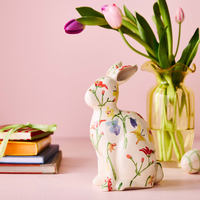 Floral statue bunny against a pink background