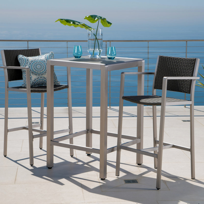Table de bar d'extérieur grise avec structure en aluminium et plateau en verre givré, légère et résistante aux chocs.