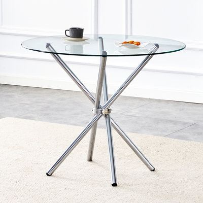 Élégante table ronde en verre transparent avec pieds en métal doré stables pouvant accueillir 4 à 6 personnes