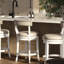 Tabouret de bar 26 po à hauteur de comptoir, structure en bois blanc avec siège et dossier en similicuir gris, retour automatique à 180 degrés, garniture cloutée entourant le siège rond, pieds incurvés, profondeur de 20,35 po, retour de largeur de 21,03 po