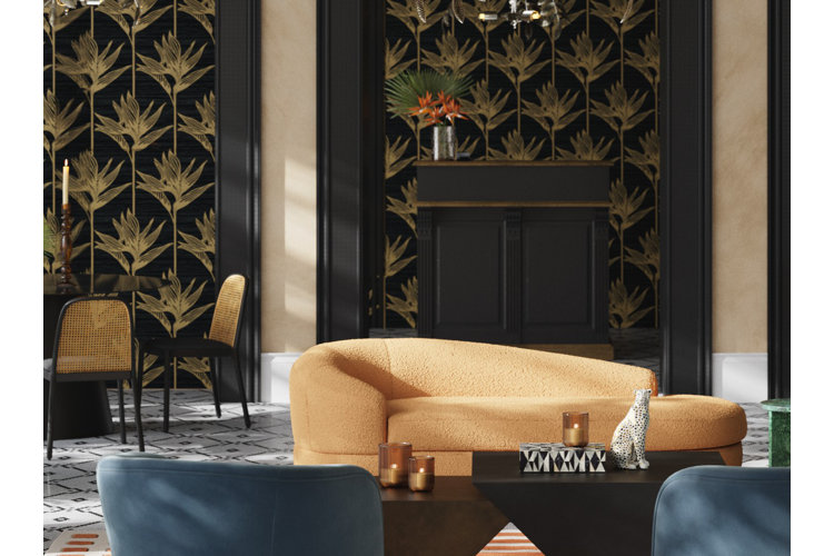 Open-concept living and dining area with black and gold botanical-patterned wallpaper and a curved orange boucle sofa.