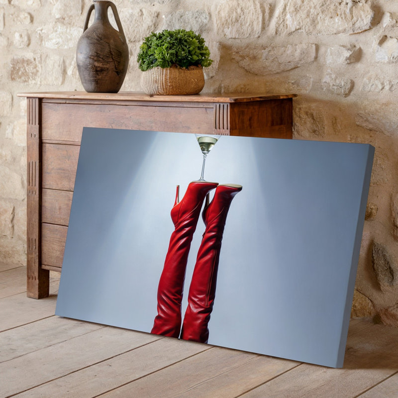 Toile d'une composition saisissante avec une paire de cuissardes rouges lustrées, des bottes à talon aiguille élégamment positionnées vers le haut contre une toile murale