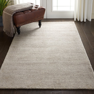 Tapis beige uni touffeté à la main