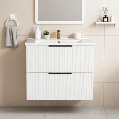 This White Wall-Mounted Floating Bathroom Vanity Is Equipped With A Ceramic Sink And Drawers, Showcasing A Stylish Modern Design.
