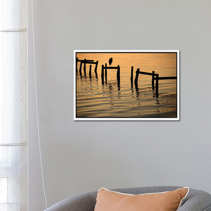 A Silhouetted Heron Perches On The Pilings Of An Old Dock by Joel Sartore - Gallery-Wrapped Canvas Giclée on Canvas