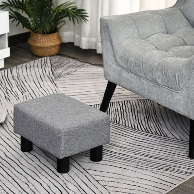 Tabouret gris avec housse en lin et pieds robustes en plastique pour le confort du salon, petit et fiable