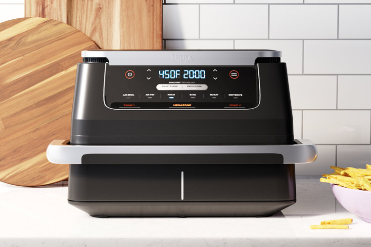 black air fryer with two wood cutting boards