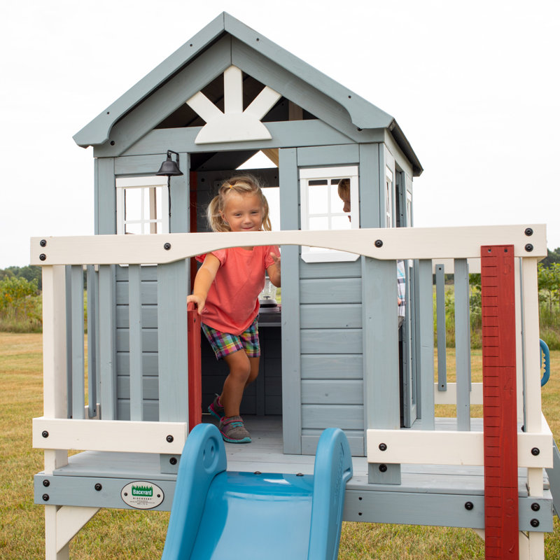 Backyard Discovery Beacon Heights Cedar Wooden Elevated Kids Playhouse with Wave Slide, Play Kitchen, and Deck