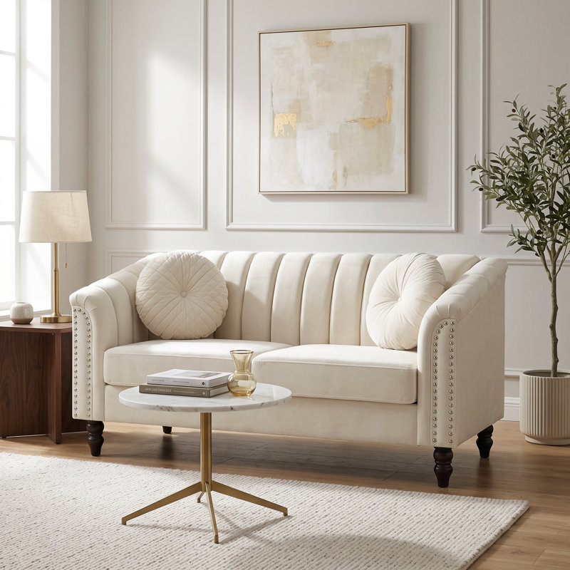 Canapé deux places blanc capitonné, avec accoudoirs arrondis et garniture cloutée., Loveseat