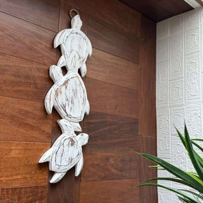 Coastal distressed white hand-carved wood three-turtle wall hanging, 24 inches high