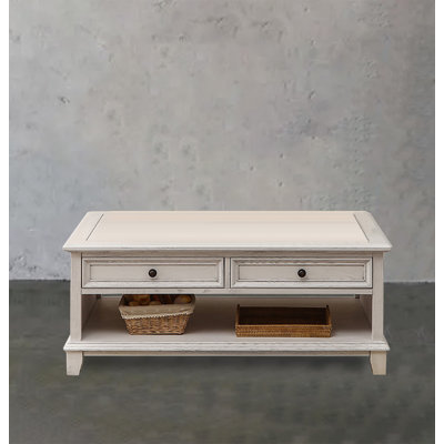 Four-drawer coffee table in solid white wood.