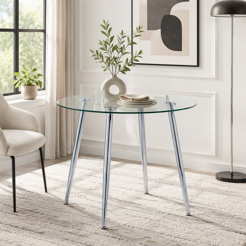 Table de salle à manger ronde avec dessus en verre et pieds argentés