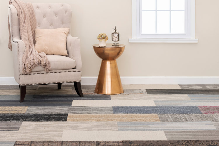 multicolored carpet tiles in a transitional seating area with an upholstered chair and metal side table