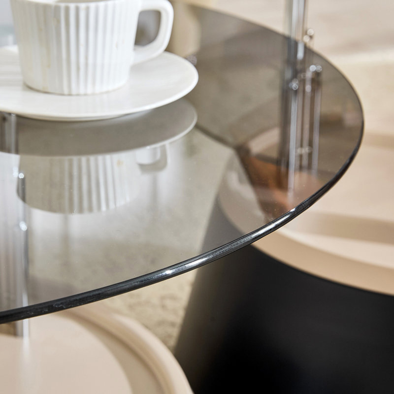 Affordable luxury black nesting coffee table set. Transparent tempered glass nesting set. Round living room coffee table, two-piece set.