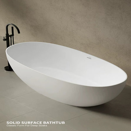 White oval solid surface freestanding bathtub with a matte black floor-mounted faucet in a modern bathroom.