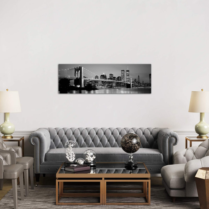 Illuminated Brooklyn Bridge With Lower Manhattan's Financial District Skyline In The Background In B&W, New York City, New York by Panoramic Images - Wrapped Canvas Panoramic Print