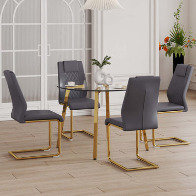 Table And Chair Set.A Modern Minimalist Style Round Clear Tempered Glass Table With Metal Legs.Paried With Chairs With Modern Pu Leather High Back Upholstered And C-Tube Golden Legs.