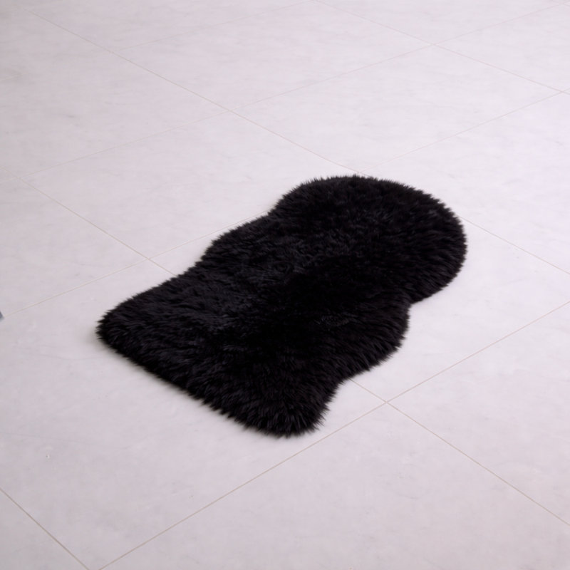 Oval Solid Colour Sheepskin 60cm X 110cm Area Rug, Black