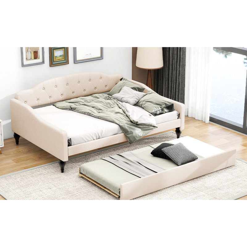 A Full-Size Upholstered Daybed With Tufted Design And A Built-In Twin-Size Trundle Bed