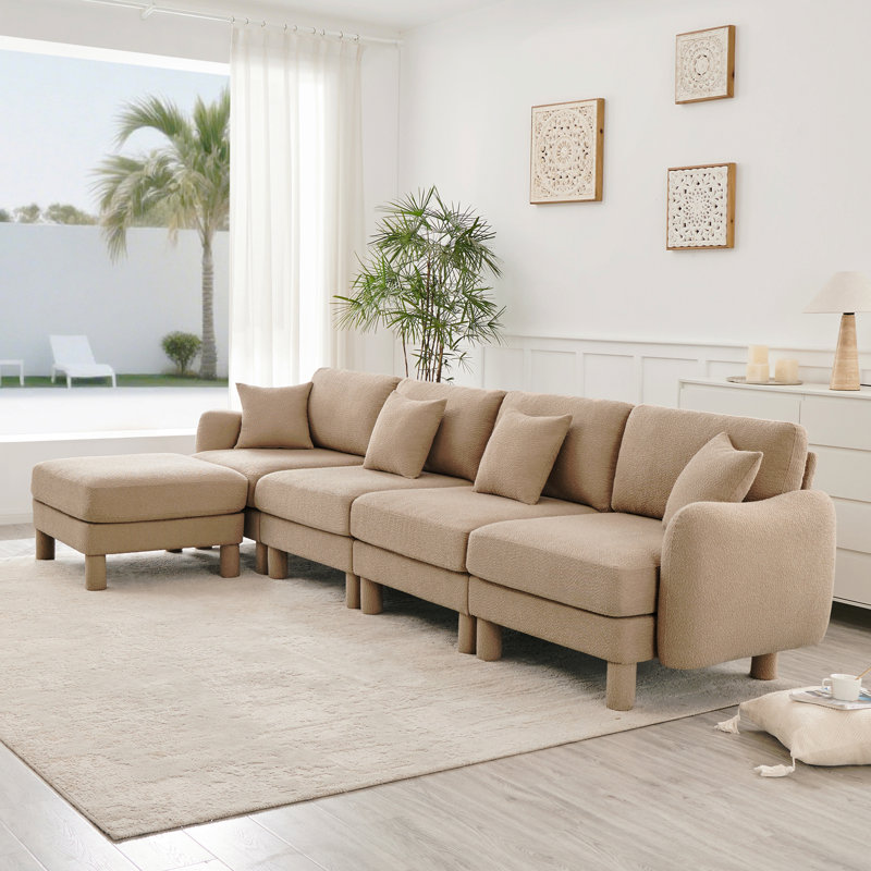 Canapé modulaire en L convertible pour 4 personnes avec accoudoirs en forme de coquillage et repose-pieds amovible Boucle