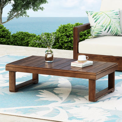Table basse rustique en bois pour l'extérieur, plateau à lattes et pieds traîneaux, couleur [couleur manquante], profondeur du plateau : 95 cm, teinte foncée, hauteur : 29 cm