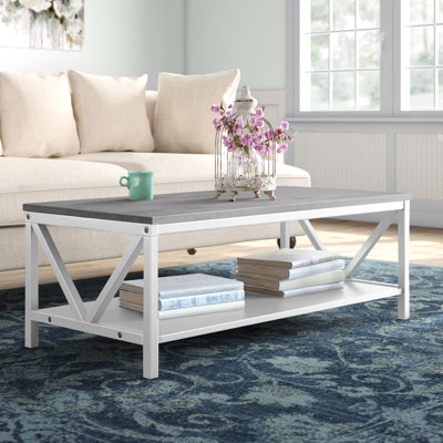 Table basse bicolore à cadre en V avec tablette de rangement inférieure
