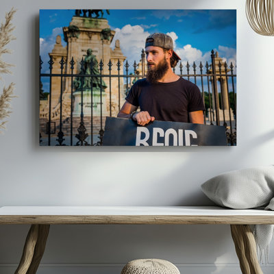 Canvas A Young Man With A Thick Beard And Long Hair Wall Art Tied Back Stands Confidently In Front Of An Ornate Black Perfect For Canvas Wall Art