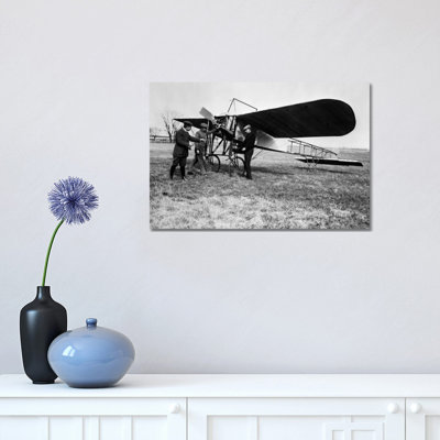 1910S Group Of Three Men Standing In Front Of Early Monoplane One With Hand On Propeller - Wrapped Canvas Print