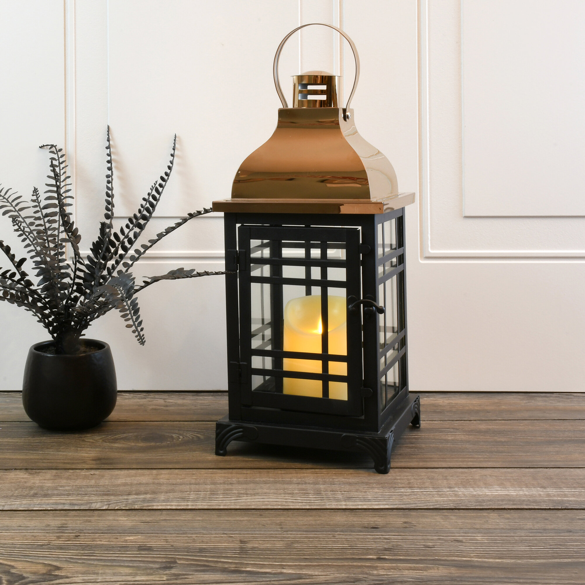 https://assets.wfcdn.com/im/04954035/compr-r85/1256/125603569/black-with-copper-roof-metal-lantern-with-moving-flame-led-candle.jpg