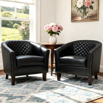 Fauteuil demi-tonneau capitonné en similicuir noir Edvardas